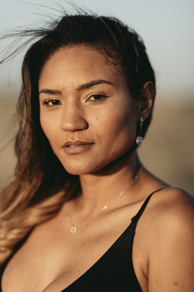 A quiet shoreline with soft waves and a path leading forward.